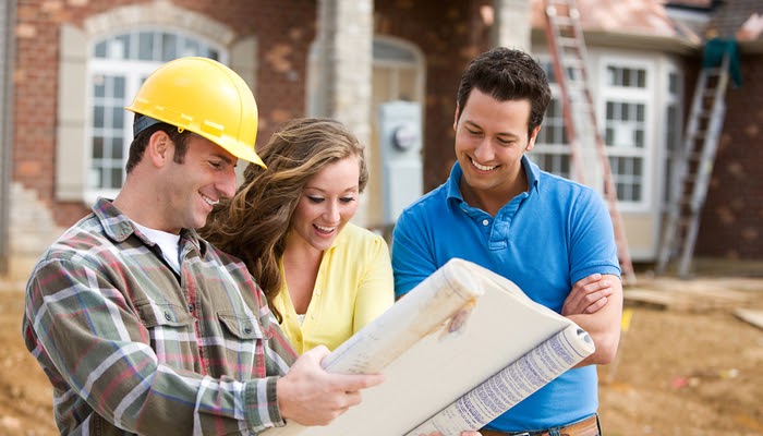 Home contractor reviewing plans with local homeowners